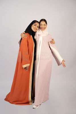 Two Gulf girls wearing modern Gulf abayas