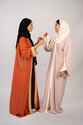 Two Gulf girls wearing modern Gulf abayas