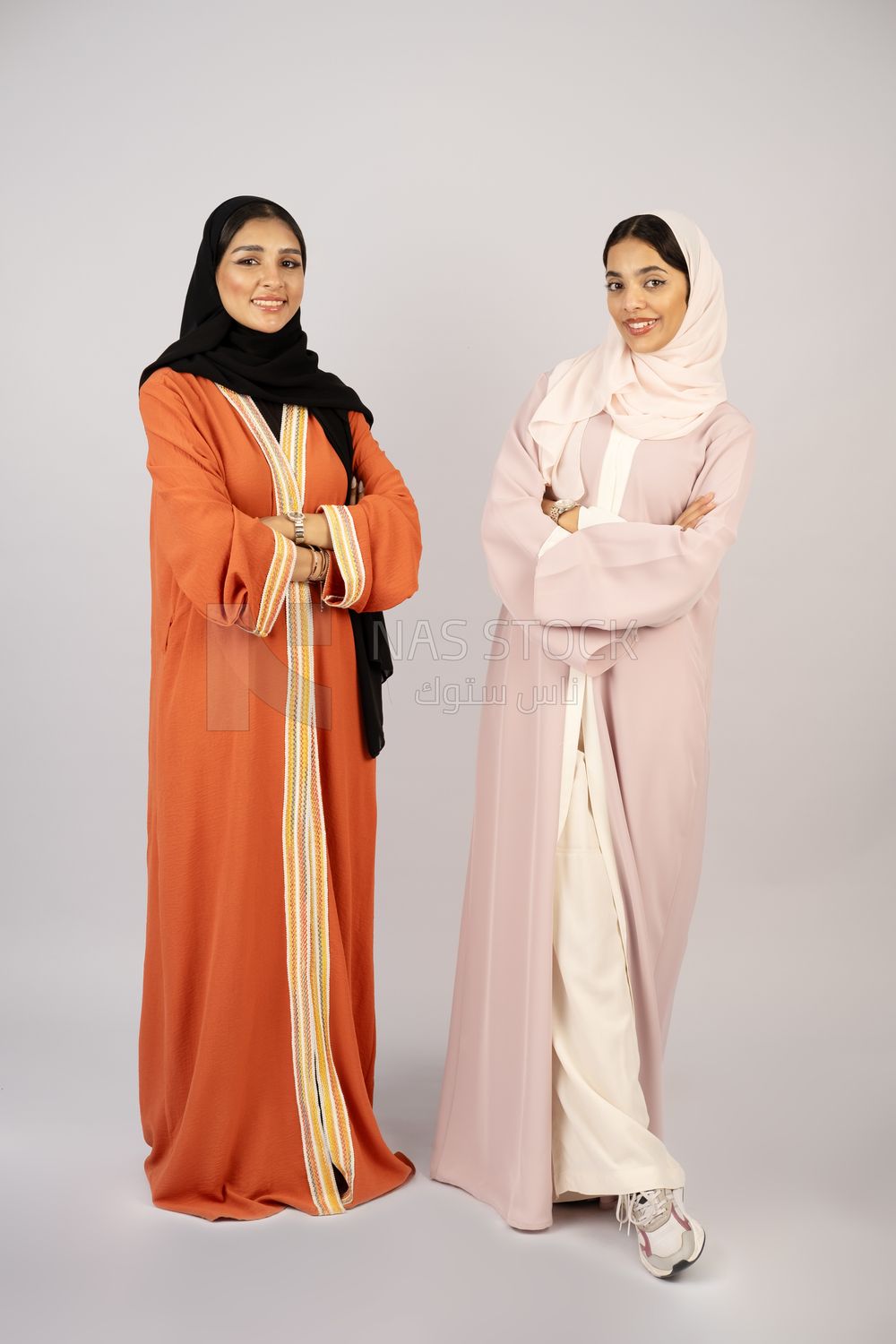 Two Gulf girls wearing modern Gulf abayas