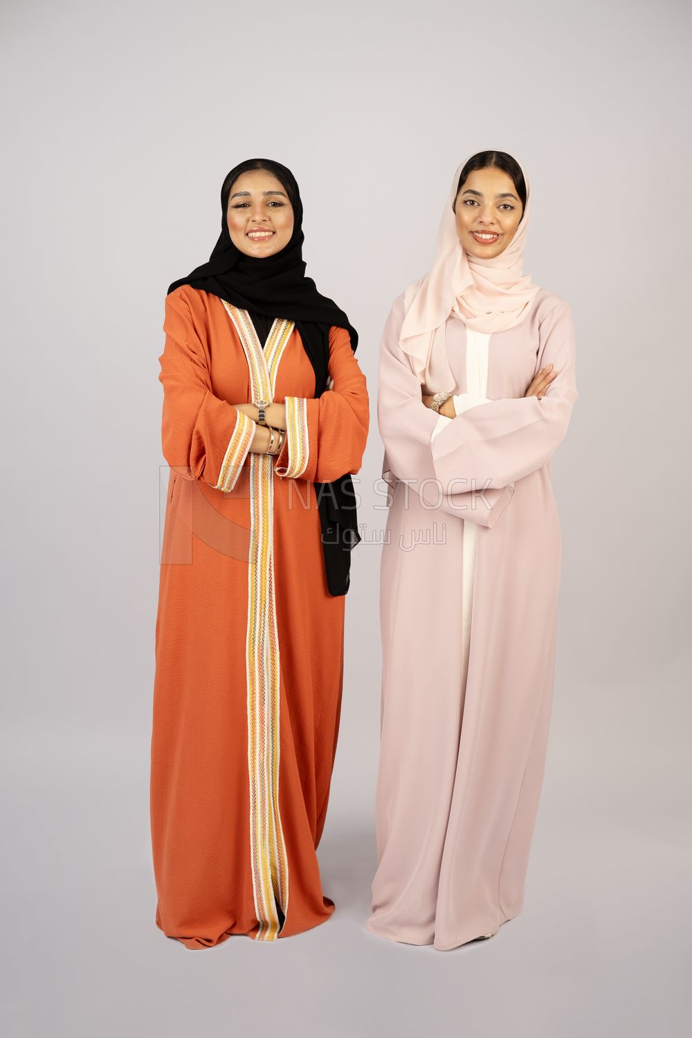 Two Gulf girls wearing modern Gulf abayas