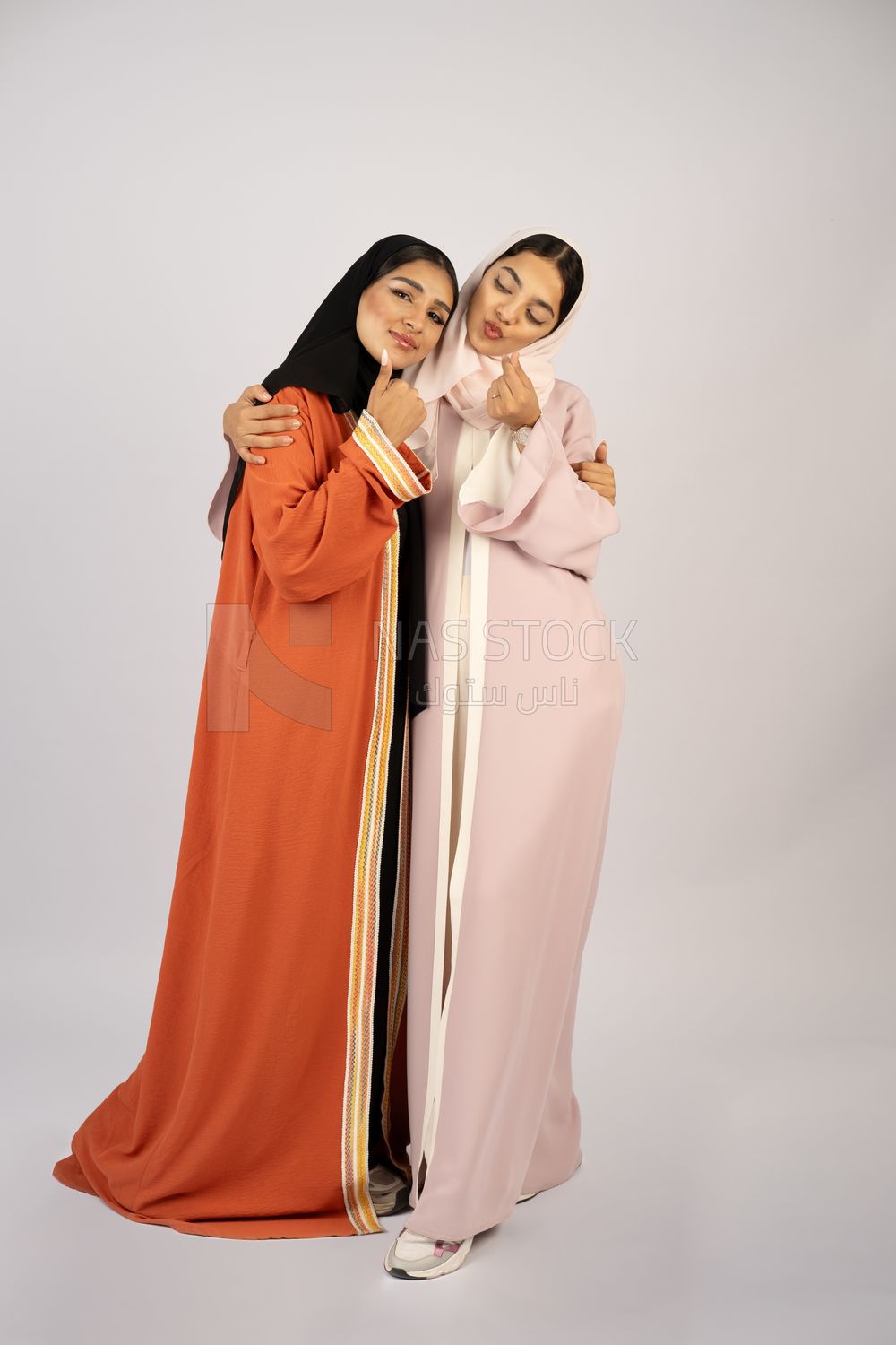 Two Gulf girls wearing modern Gulf abayas