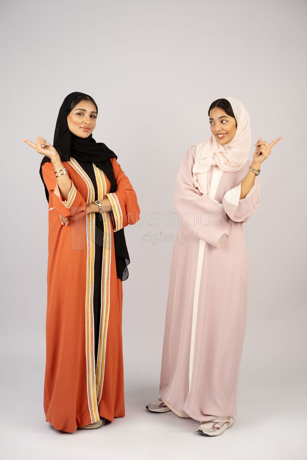 Two Gulf girls wearing modern Gulf abayas