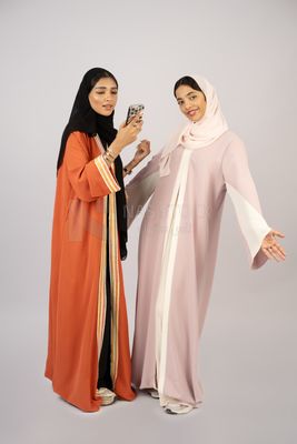 Two Gulf girls wearing modern Gulf abayas