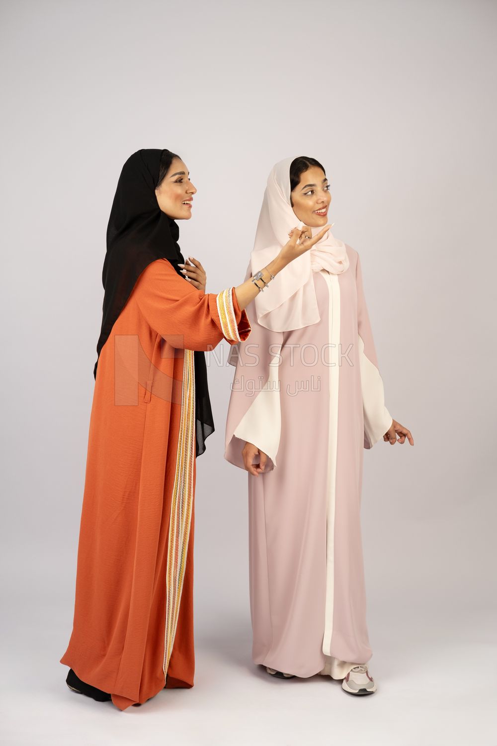 Two Gulf girls wearing modern Gulf abayas