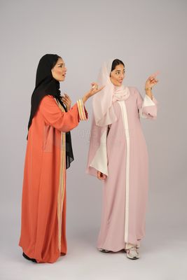 Two Gulf girls wearing modern Gulf abayas