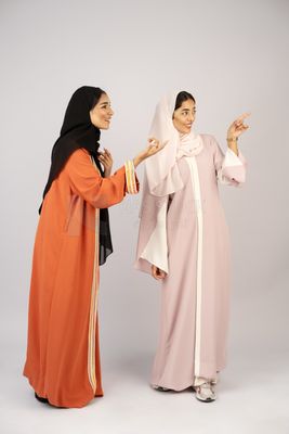 Two Gulf girls wearing modern Gulf abayas