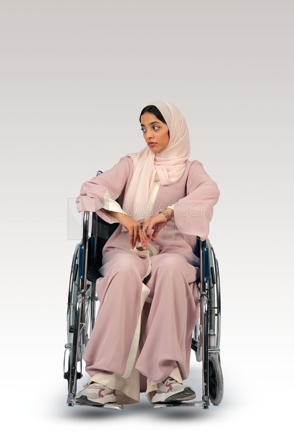 Gulf girl with special needs sits in a wheelchair