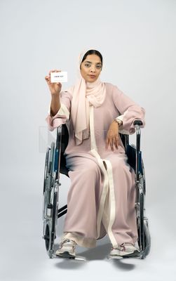 Gulf girl with special needs sits in a wheelchair