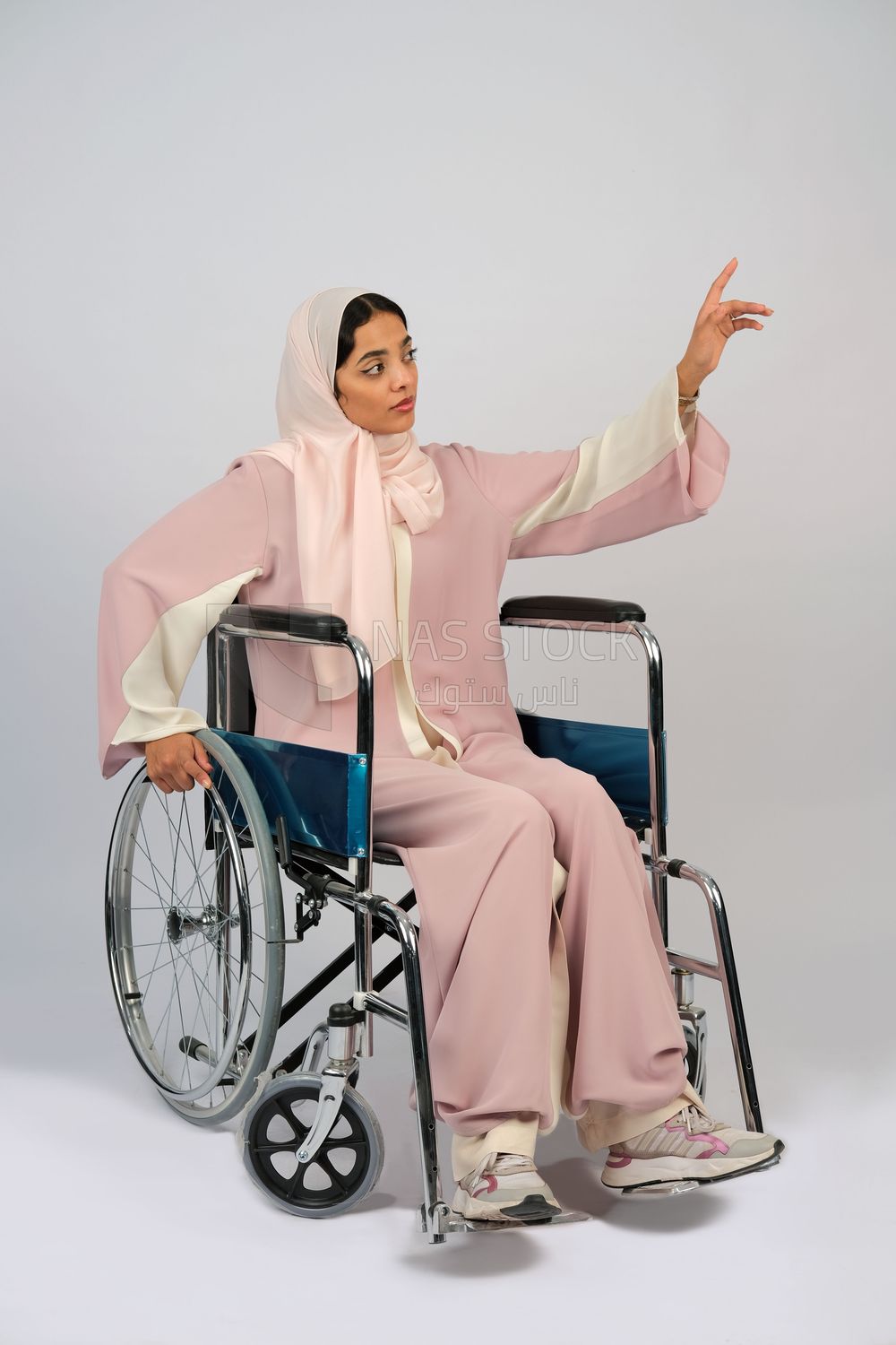 Gulf girl with special needs sits in a wheelchair