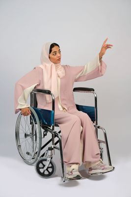 Gulf girl with special needs sits in a wheelchair