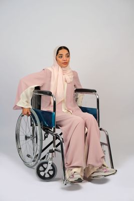 Gulf girl with special needs sits in a wheelchair
