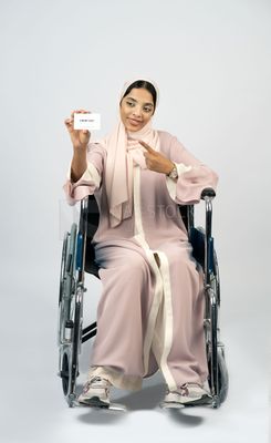 Gulf girl with special needs sits in a wheelchair
