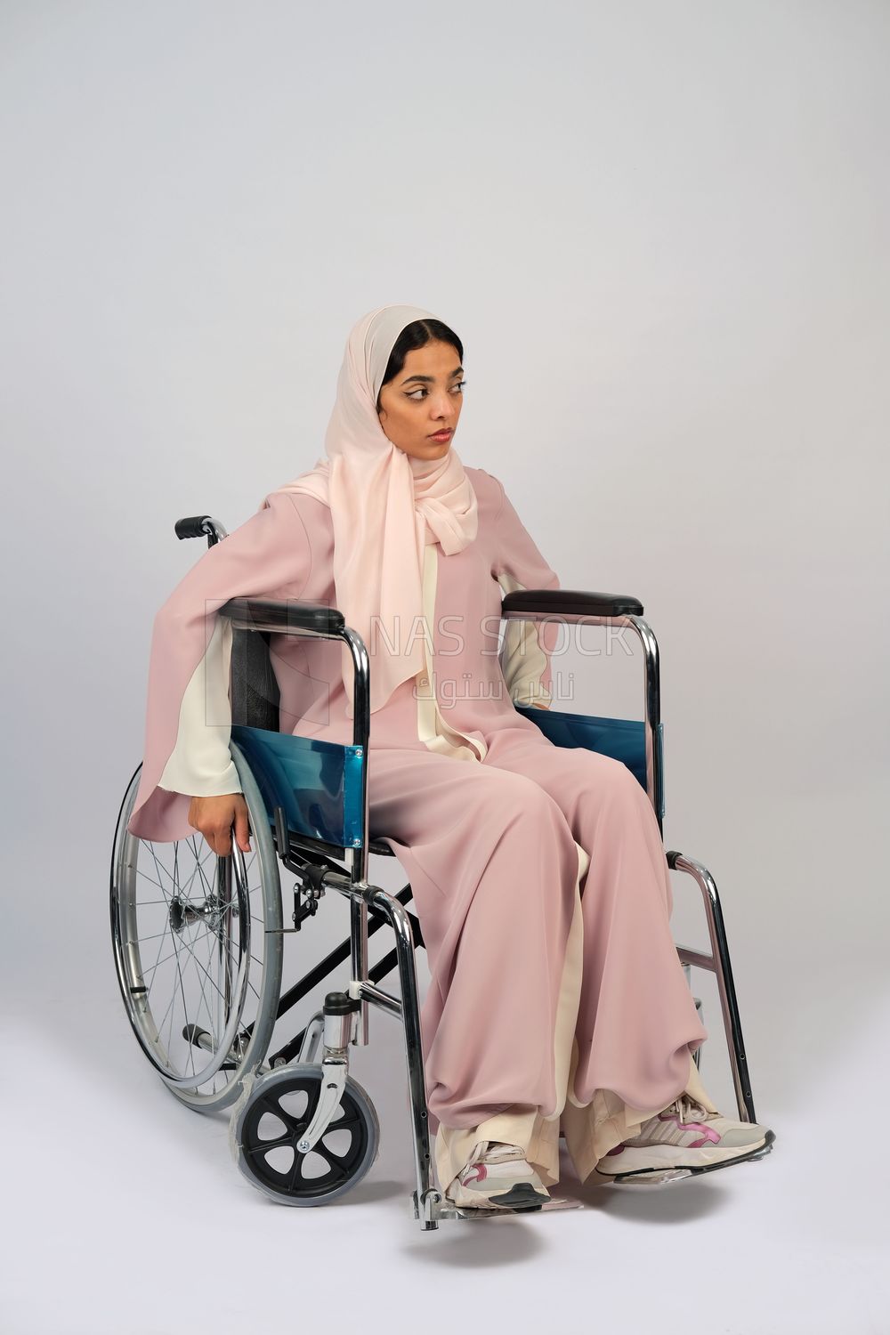 Gulf girl with special needs sits in a wheelchair