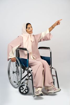 Gulf girl with special needs sits in a wheelchair