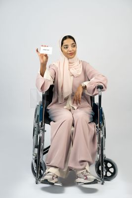 Gulf girl with special needs sits in a wheelchair