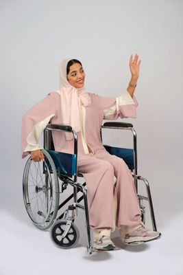 Gulf girl with special needs sits in a wheelchair