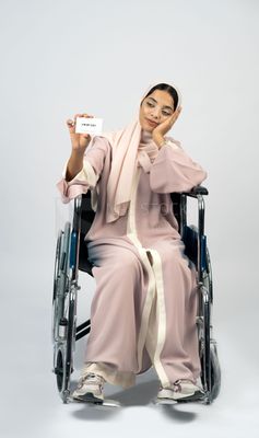 Gulf girl with special needs sits in a wheelchair