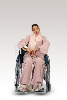 Gulf girl with special needs sits in a wheelchair