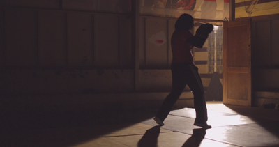Veiled girl training in boxing, bodybuilding, violent sports and self-defense, wrestling and sports