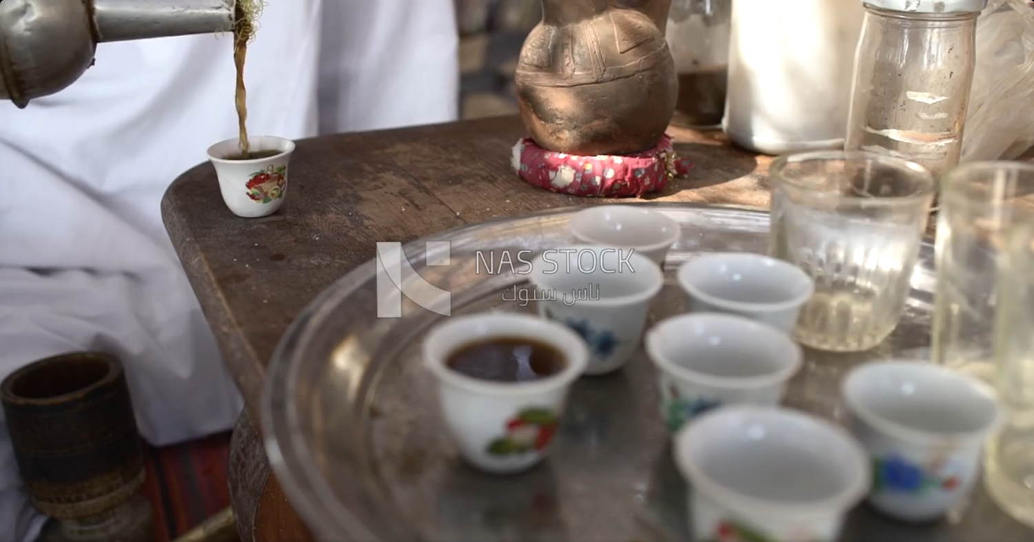 Hand put the tea in the cup