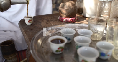 Hand put the tea in the cup