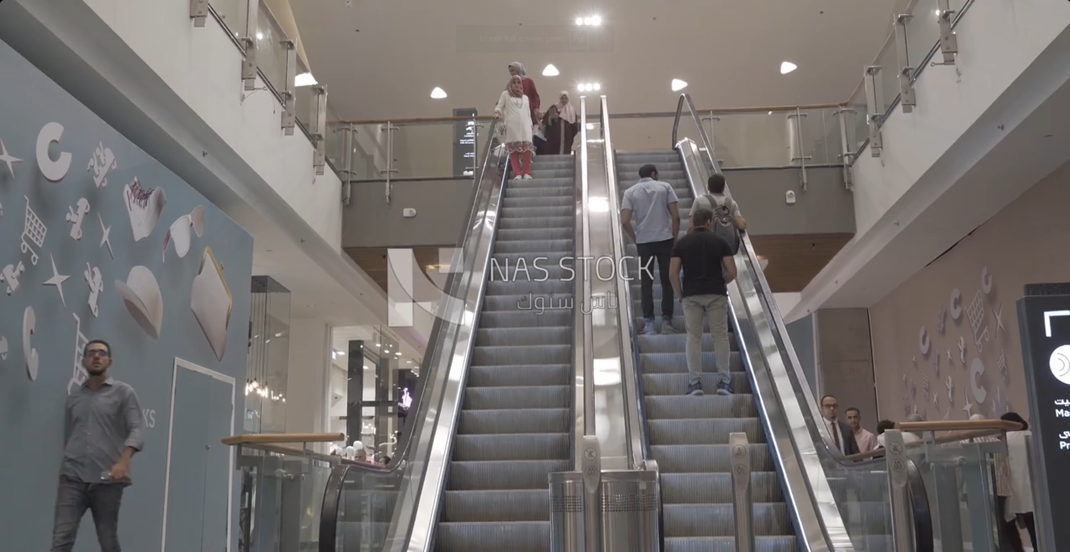 People on an electric ladder in the mall