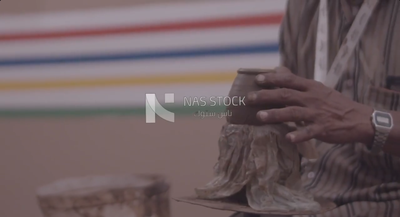 Man making pots using a pottery wheel
