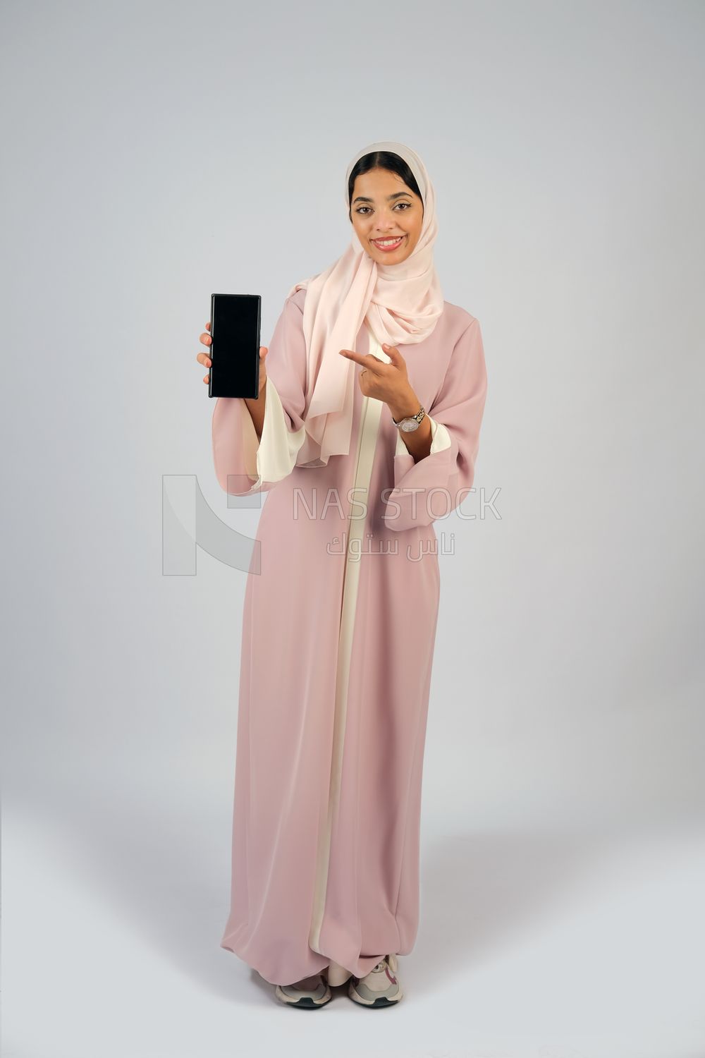 Gulf girl holding a mobile phone with a blank black screen