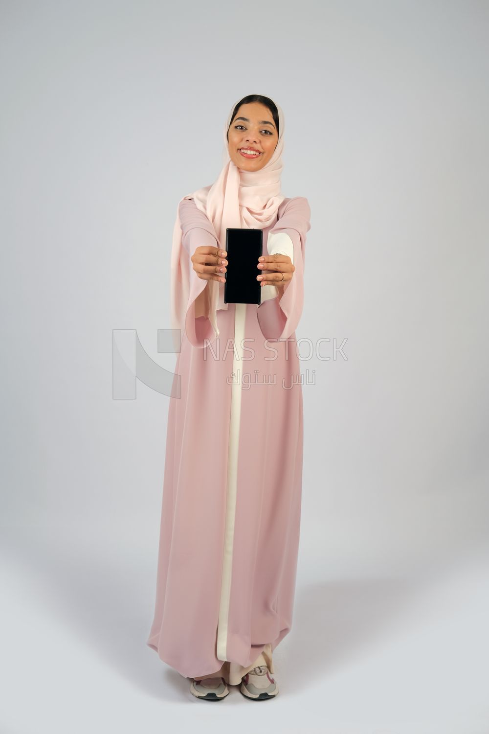 Gulf girl holding a mobile phone with a blank black screen