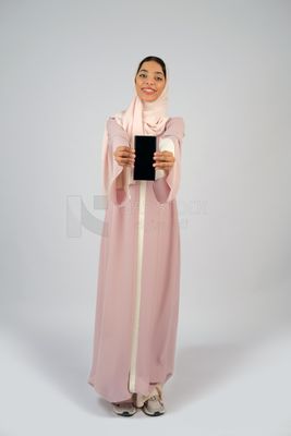 Gulf girl holding a mobile phone with a blank black screen
