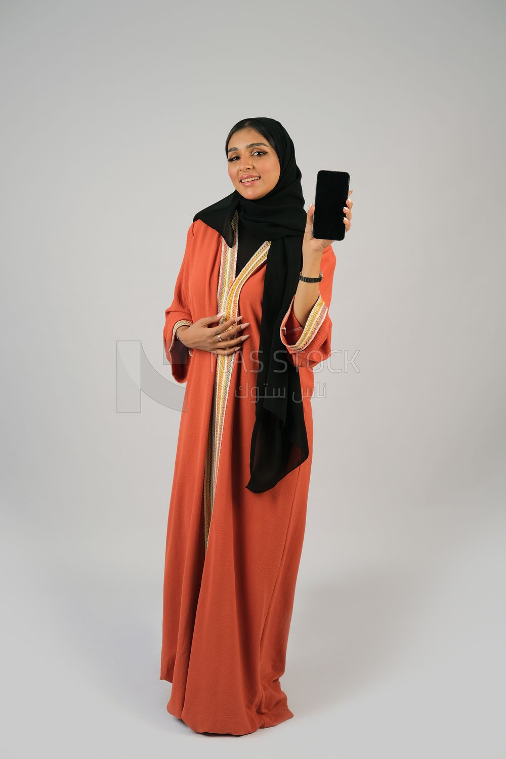 Gulf girl holding a mobile phone with a blank black screen