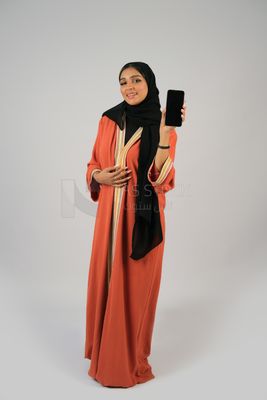 Gulf girl holding a mobile phone with a blank black screen