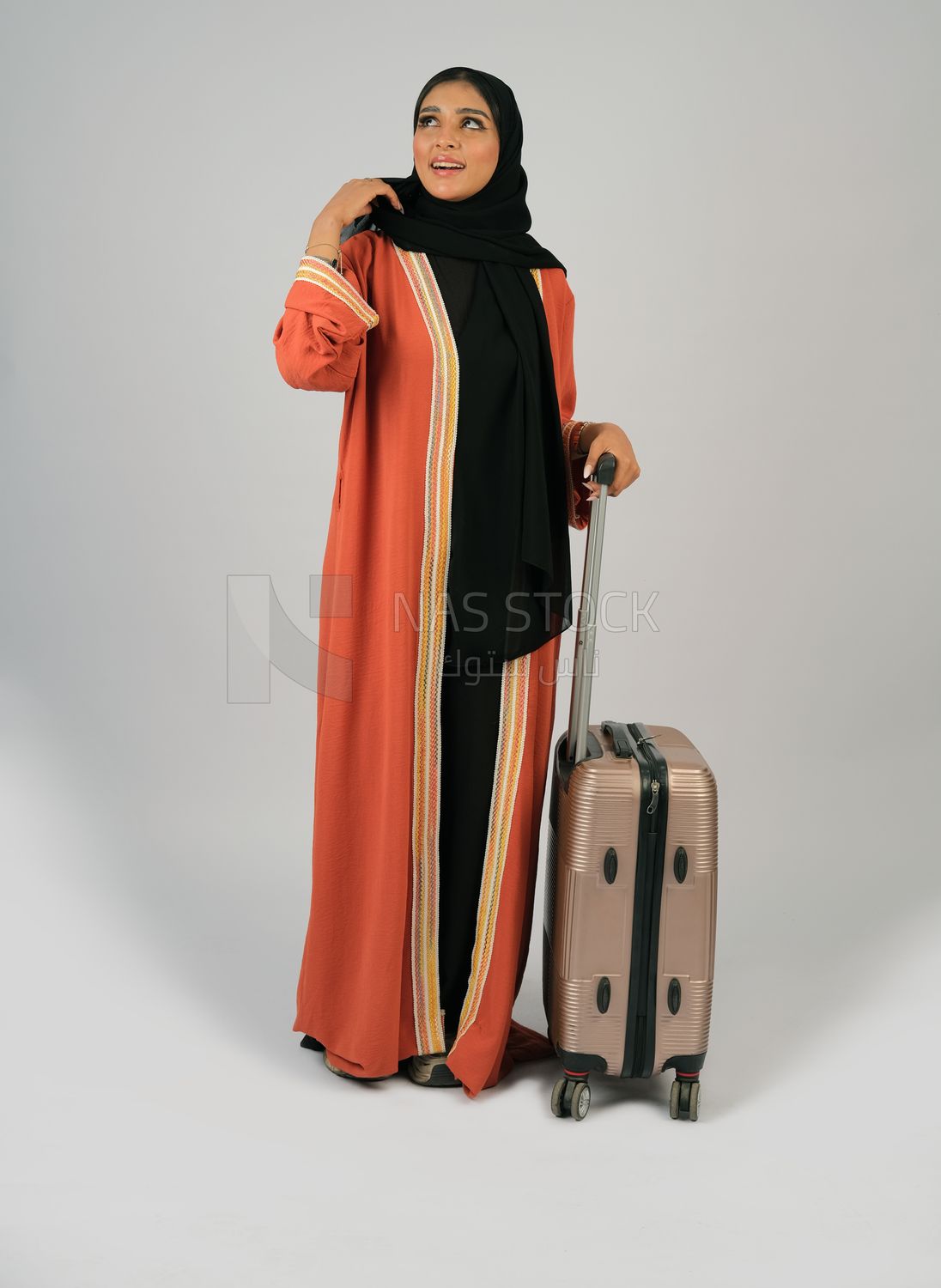 Saudi Gulf girl holding a suitcase in her hand