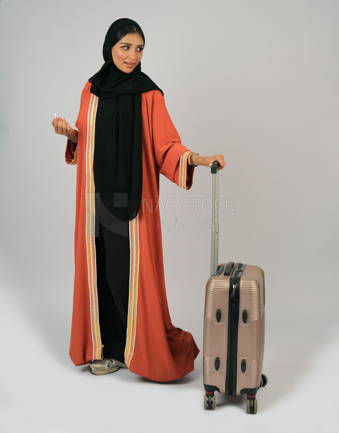 Saudi Gulf girl holding a suitcase in her hand