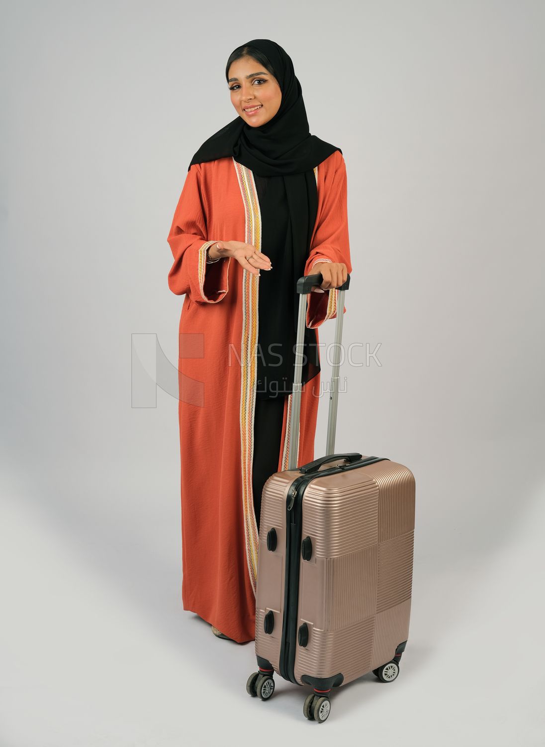 Saudi Gulf girl holding a suitcase in her hand