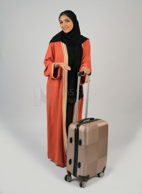 Saudi Gulf girl holding a suitcase in her hand