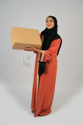 Saudi Gulf girl holding a cardboard delivery box