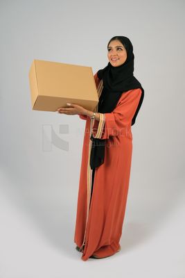Saudi Gulf girl holding a cardboard delivery box