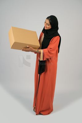 Saudi Gulf girl holding a cardboard delivery box