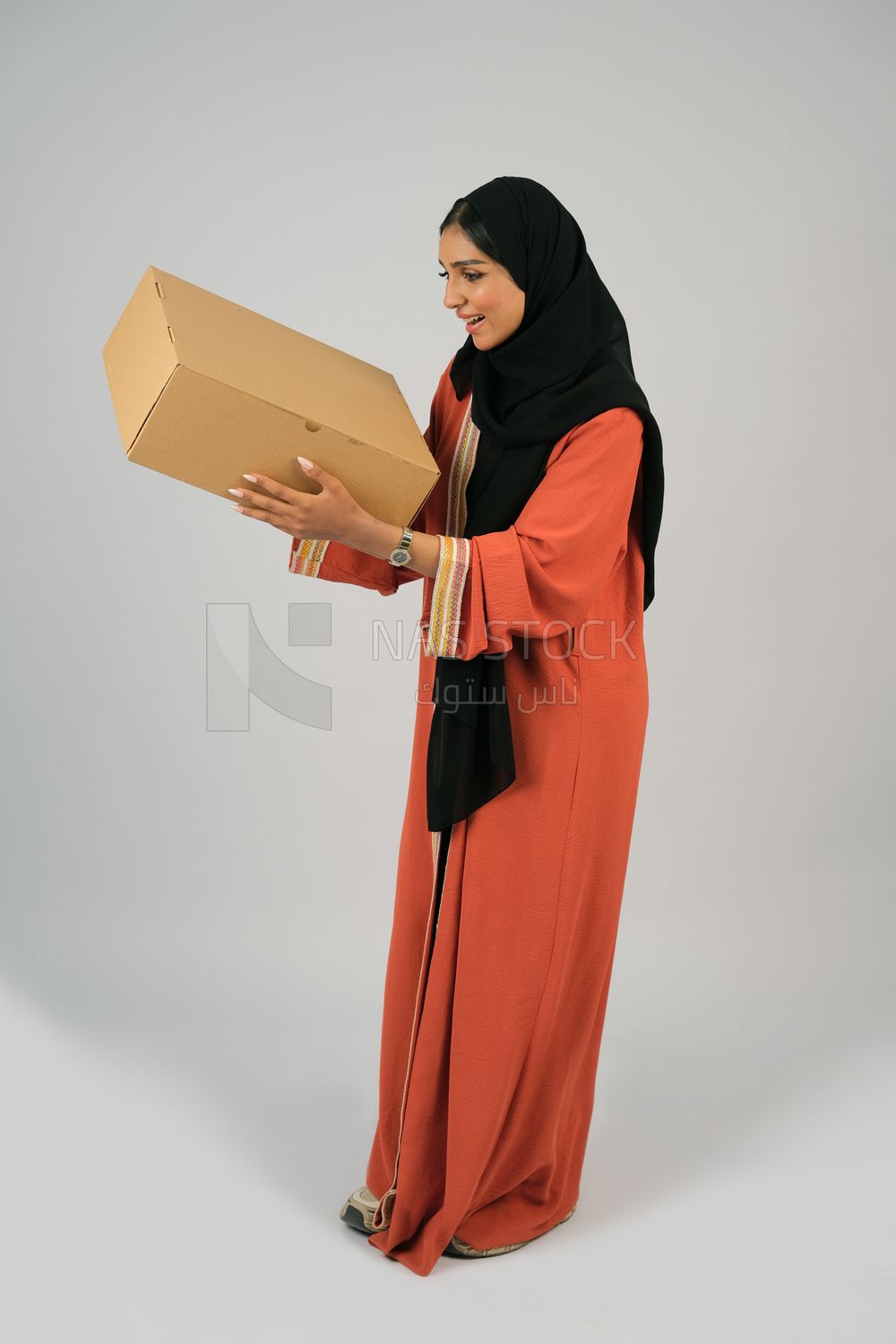 Saudi Gulf girl holding a cardboard delivery box