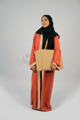 Saudi Gulf girl holding a cardboard delivery box