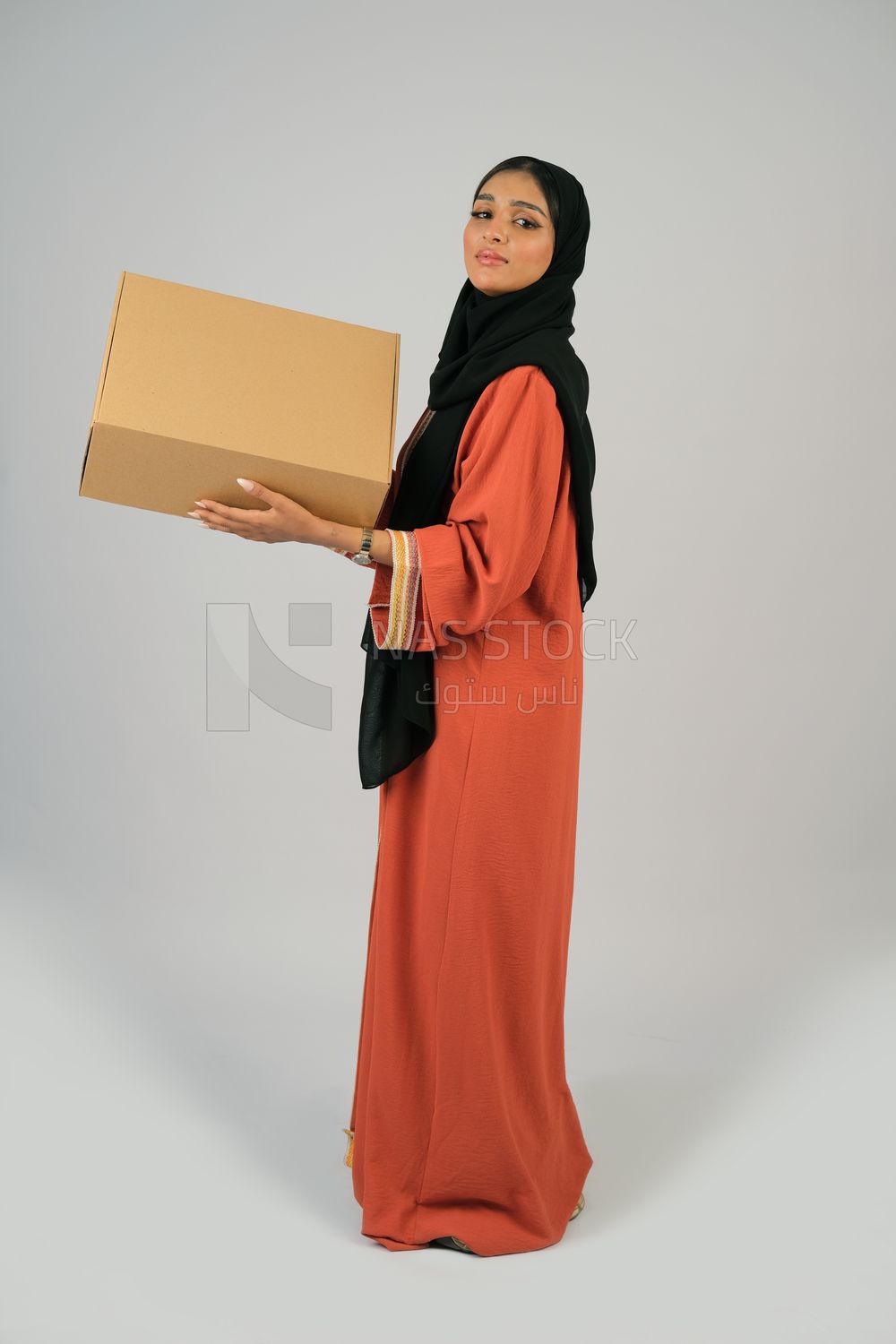 Saudi Gulf girl holding a cardboard delivery box