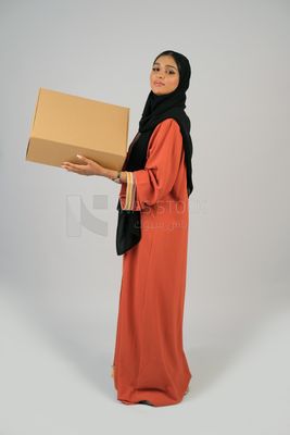 Saudi Gulf girl holding a cardboard delivery box