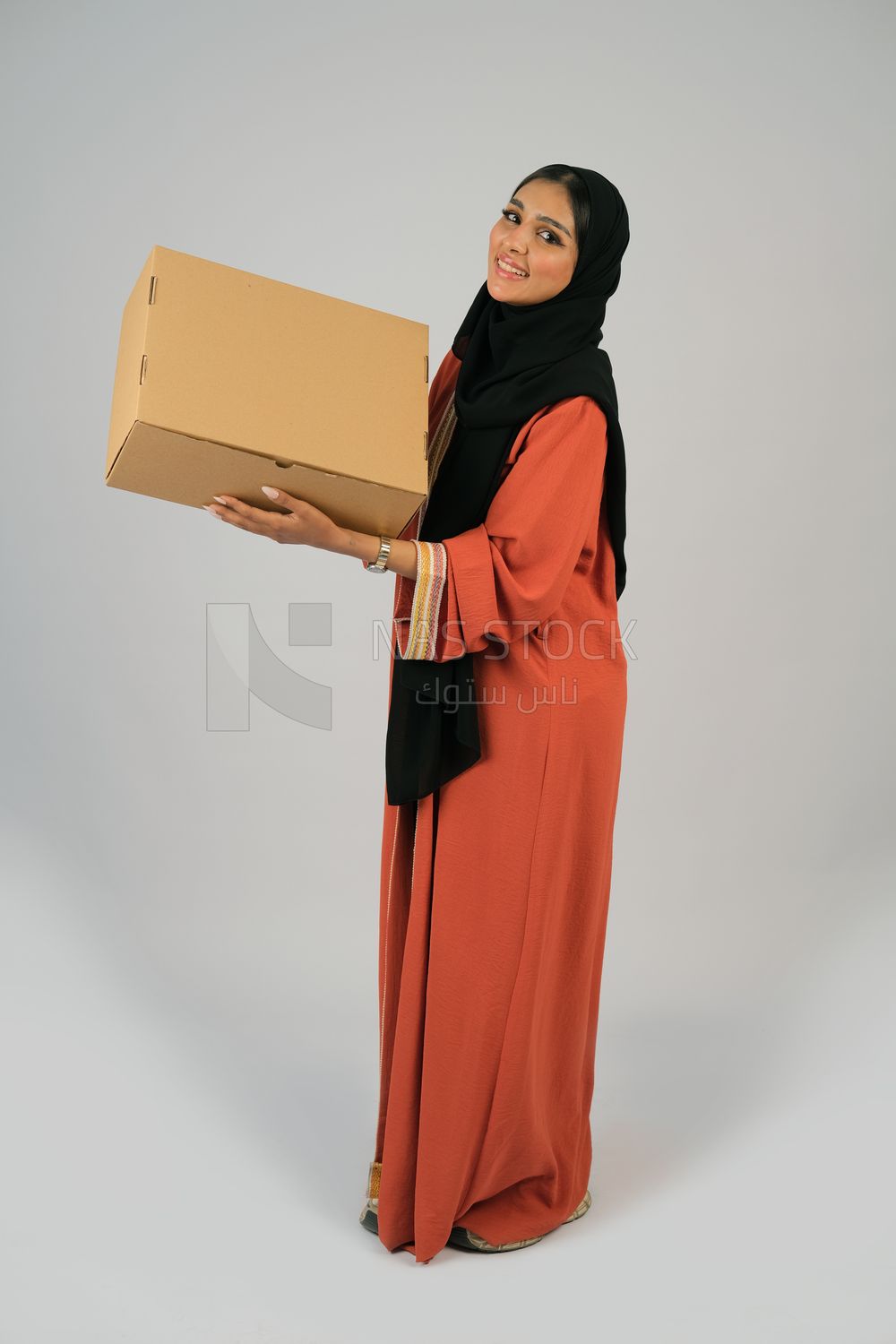 Saudi Gulf girl holding a cardboard delivery box