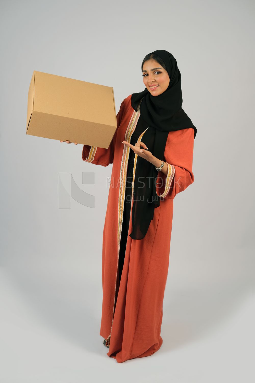 Saudi Gulf girl holding a cardboard delivery box