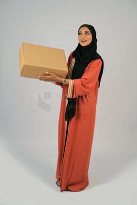 Saudi Gulf girl holding a cardboard delivery box