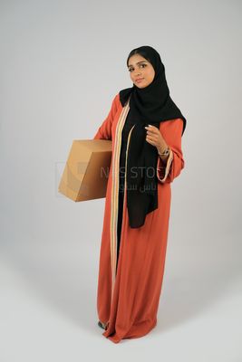 Saudi Gulf girl holding a cardboard delivery box