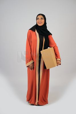 Saudi Gulf girl holding a cardboard delivery box