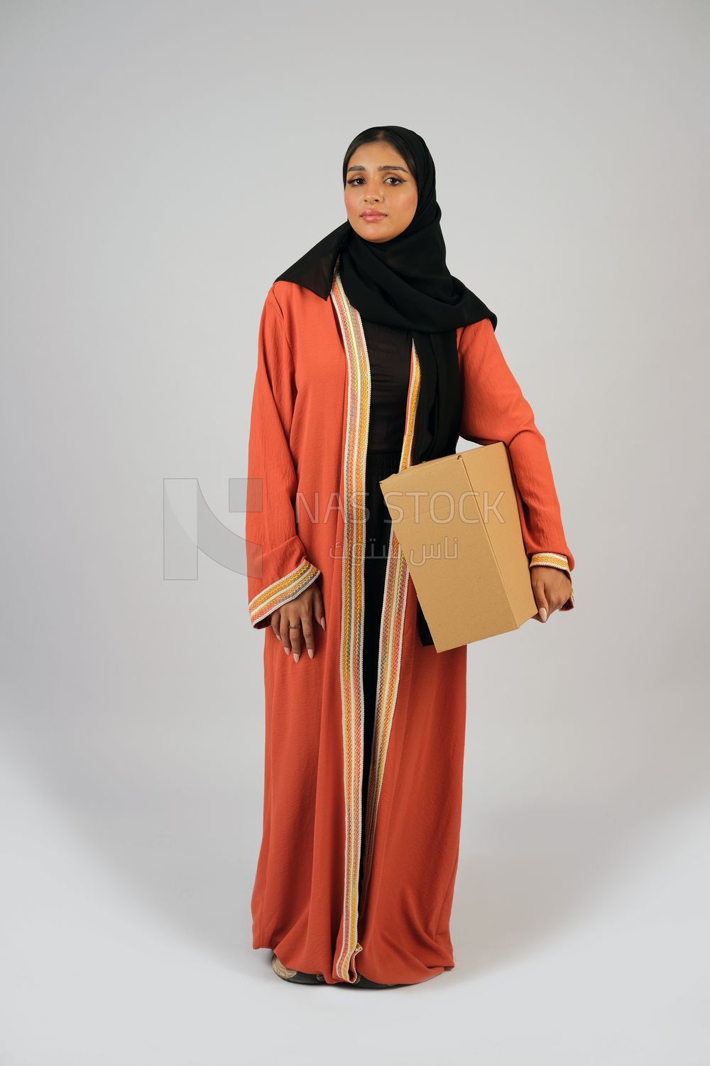 Saudi Gulf girl holding a cardboard delivery box