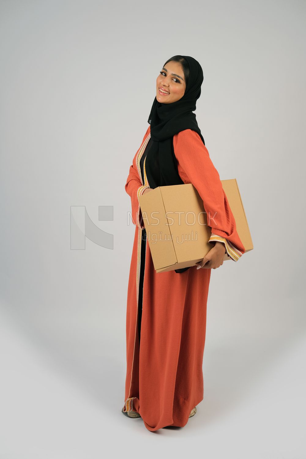 Saudi Gulf girl holding a cardboard delivery box